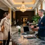 Concierge accueille une cliente à la réception luxueuse